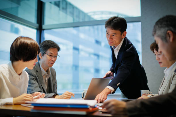 unternehmer an einem tisch mit einem treffen - japaner stock-fotos und bilder