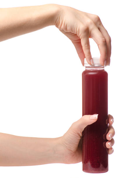 istock Berry fruit drink in a bottle of a female hand 867869906