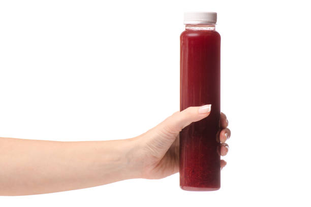 istock Berry fruit drink in a bottle of a female hand 867869986