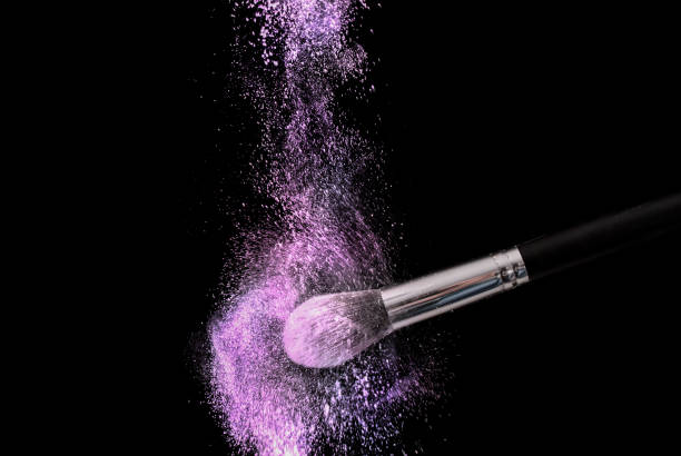 istock Purple powder explosion dust and make up brush on black background 867872740