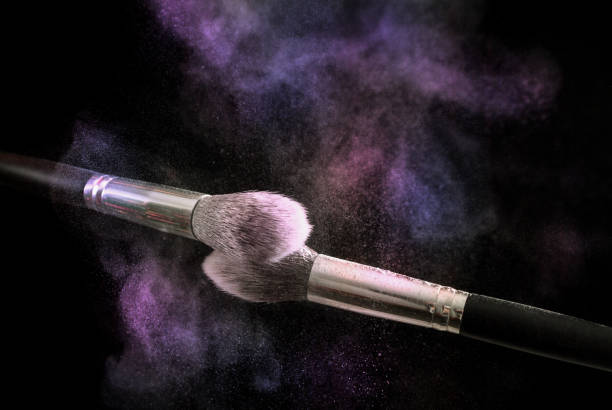 istock Two make up brushes with colorful powder explosion dust cloud 867872746