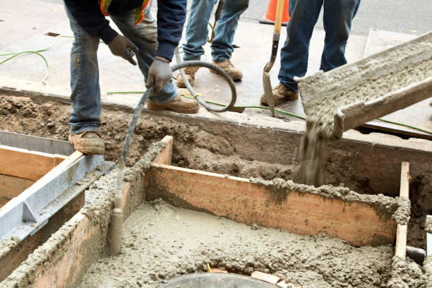 istock Worker removing bubbles with Immersion Vibrator in newly poured cement 867873236