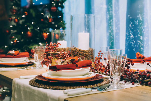 Festive place setting table, next to the Christmas tree