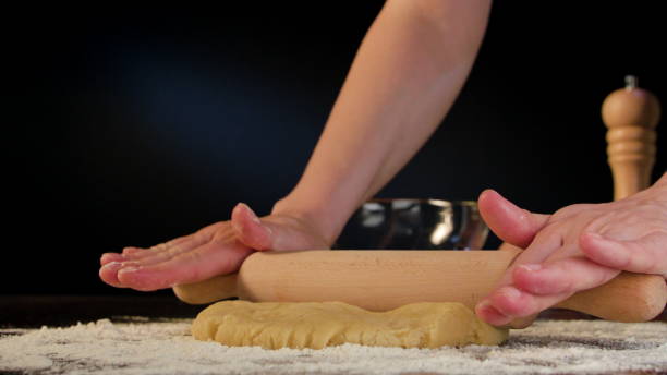 istock Female Hands Rolling Out Dough on the Table 867882440