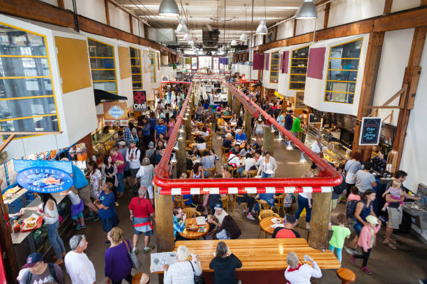 Granville Island Public Market Visitors eating at the Granville Island Public Market in Vancouver, Canada. It's home to over 100 vendors offering fresh seafood, meats, and specialty foods. Granville Island is located across False Creek from downtown Vancouver. granville island stock pictures, royalty-free photos & images