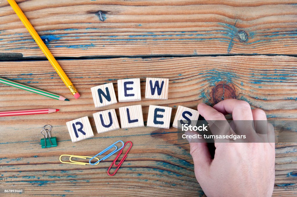 new rules. Wooden letters on the office desk Rules Stock Photo