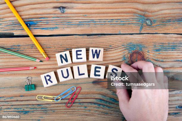 New Rules Wooden Letters On The Office Desk Stock Photo - Download Image Now - Rules, New, Retirement