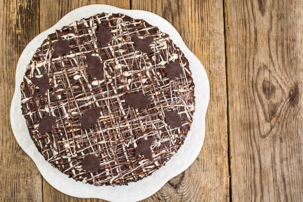 istock Homemade cake with chocolate icing on wooden table 867896684