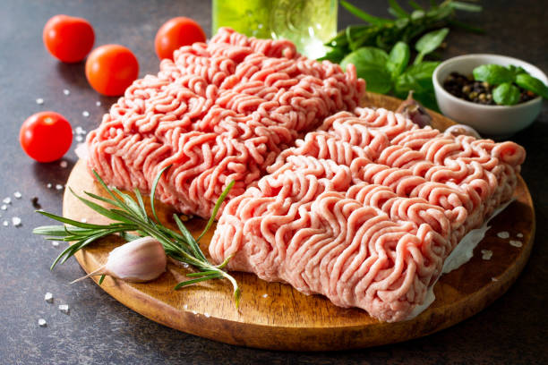 istock Minced beef and pork on a cutting board, raw meat and various spices on a stone or slate background. 867896992