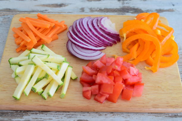 istock Cut and diced vegetables on a wooden cutting board. 867899682