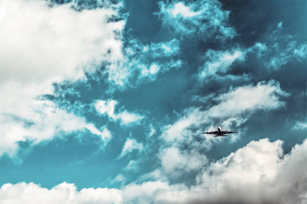 istock Airplane flying on a cloudy sky 867899908