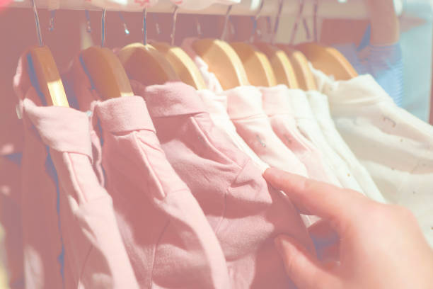 istock Clothes hanging on a hanger in a store. Baby clothes. 867909754