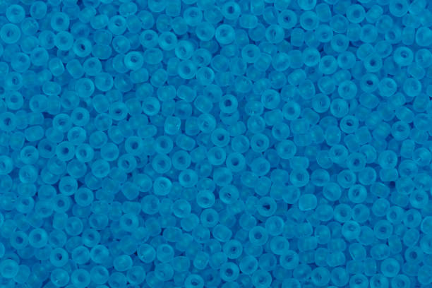 istock Photograph of multicolored blue glass seed beads background 867909812
