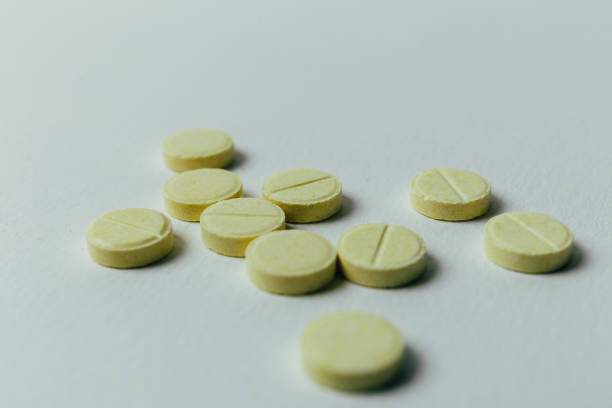 istock Yellow pills on a light background 867918860