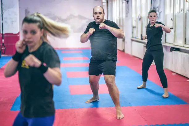 A group is doing self - defence exercises