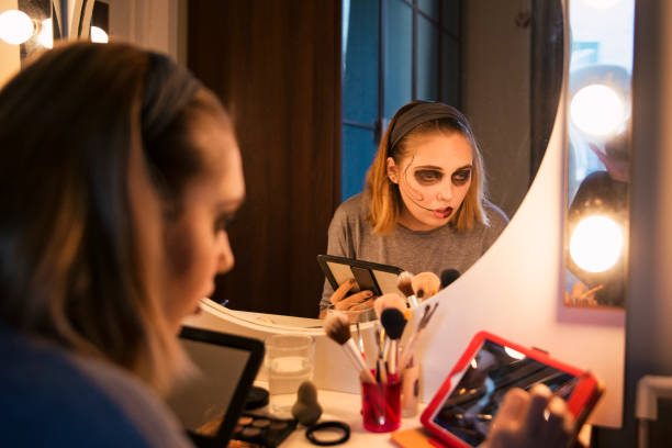 Young woman following a makeup tutorial on social media at home