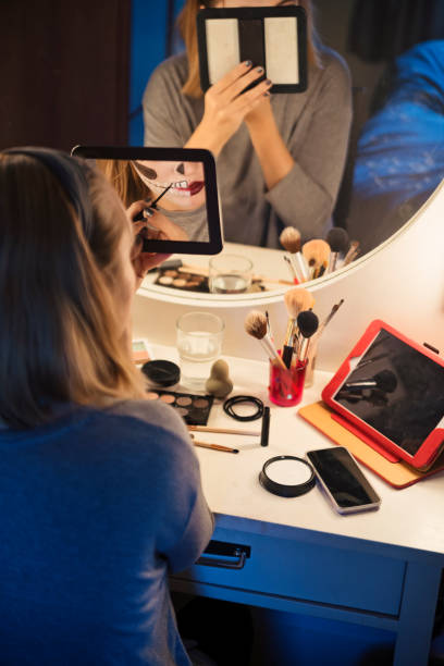 istock Young woman following a makeup tutorial on social media at home 867922776