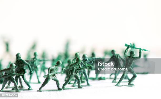 Many Green Army Plastic Toy Soldiers Organized On Top Of A White Surface And Background Isolated With Out Of Focus Plastic Soldiers In The Background Stock Photo - Download Image Now