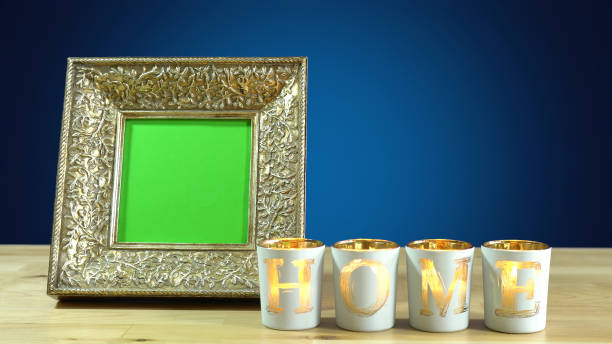 Photo frames in elegant interiors display. Antique photo frame with green screen and burning home candles in elegant table interiors display chroma key photos stock pictures, royalty-free photos & images