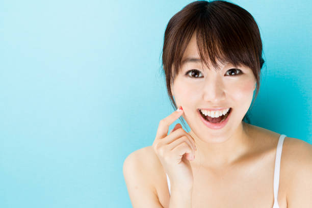 istock attractive asian woman beauty image isolated on blue background 867940524