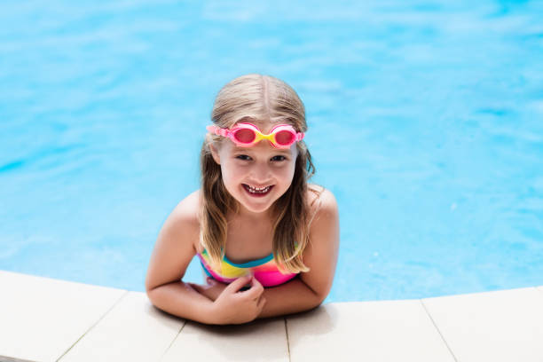 istock Child with goggles in swimming pool. Kids swim. 867942122