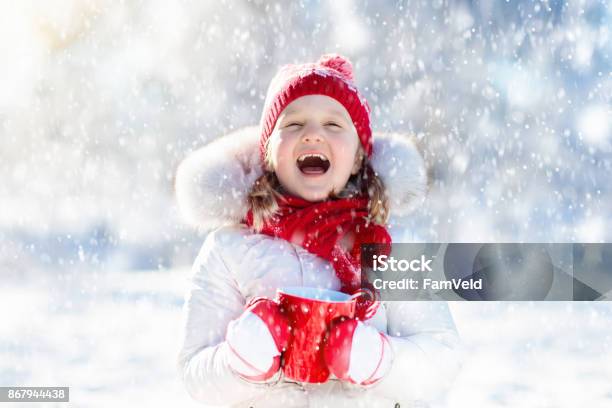 Child Drinking Hot Chocolate In Winter Park Kids In Snow On Christmas Stock Photo - Download Image Now