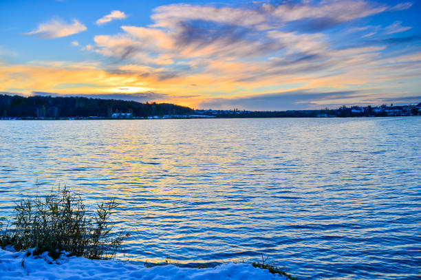 istock The setting sun on a snowy lake in late autumn 867945144
