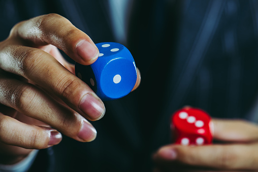 businessman holding a dice