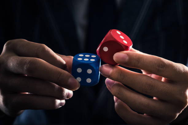 istock businessman holding a dice 867951278