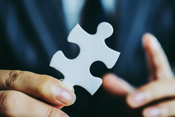 istock businessman holding a Puzzle piece 867951400