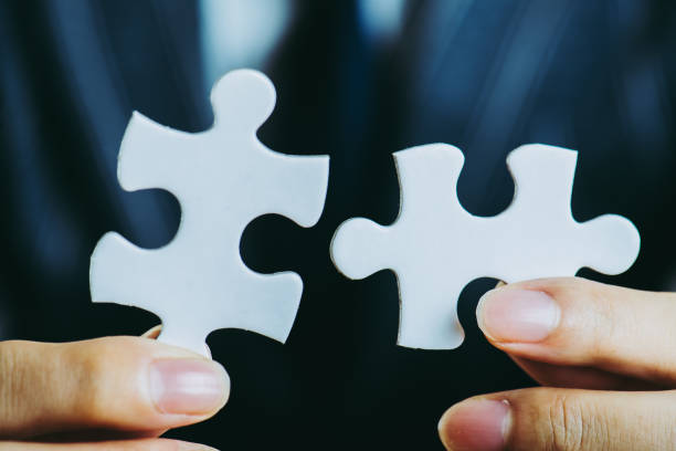 istock businessman holding a Puzzle piece 867951418