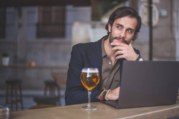 istock Attractive man working on laptop in cafe 867962048