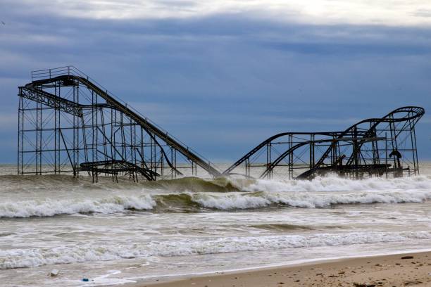 Seaside Heights' Jetstar roller coaster after Superstorm Sandy December 5, 2012 -Seaside Heights, NJ, USA: Superstorm Sandy left the Jetstar roller coaster sitting in the Atlantic Ocean. One month later, it still remains a symbol of the destruction in Seaside heights, New Jersey. superstorm stock pictures, royalty-free photos & images