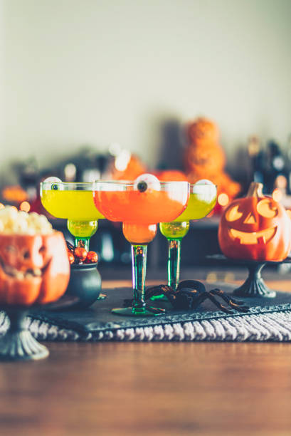 istock Halloween time. Vibrant colored drinks with cauldron of candy 867979076