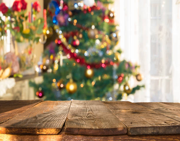 istock christmas table background with christmas tree out of focus 867985556