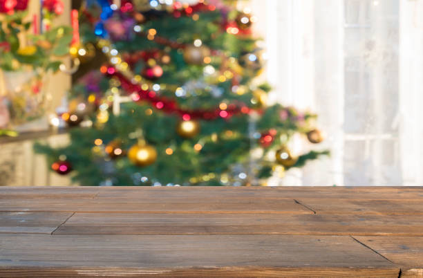 istock christmas table background with christmas tree out of focus 867985598