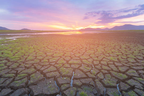 istock Cracked ground skyline with beautiful sunset background 867991924