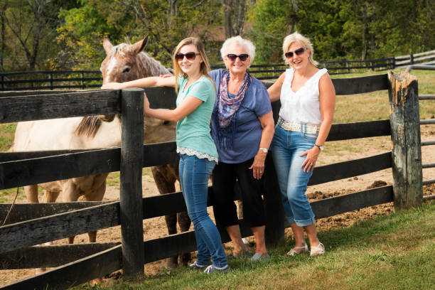 istock Three generation blond women and Palomino horses 867994354