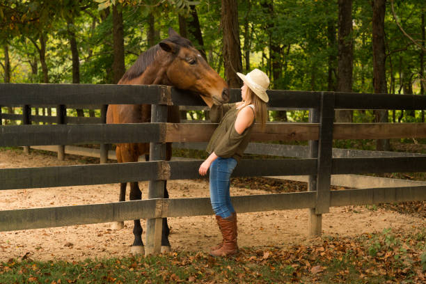 istock Teen interacting with thoroughbred horse 867994376