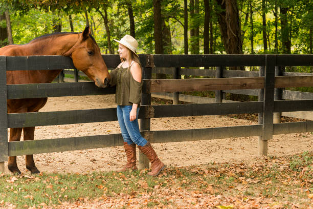 istock Teen interacting with thoroughbred horse 867994392
