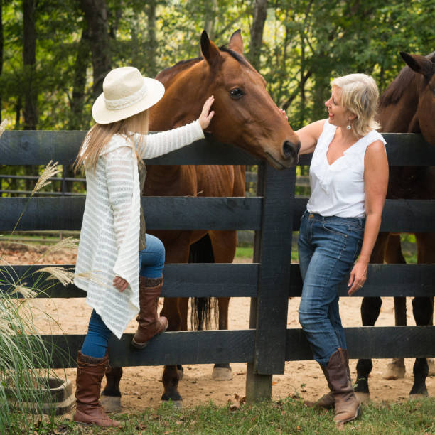 istock Mother and daughter with thoroughbred horse 867994472