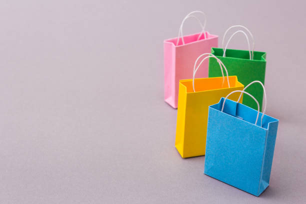 istock Color packets for purchases on a gray background. Copy space for text 867994970