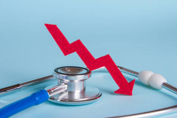 istock Prices are falling. Arrow diagram grows up near a stethoscope 867995292
