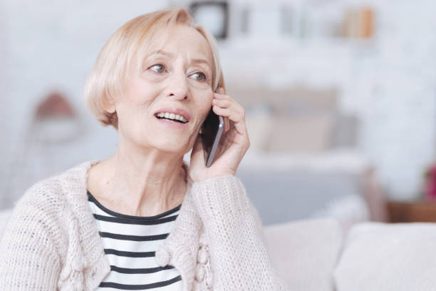 istock Excited retired woman having smartphone call indoors 867998514