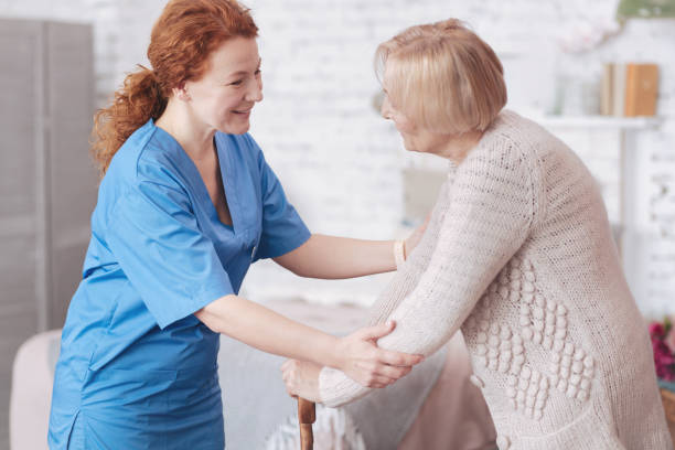 istock Positive caregiver having pleasant conversation with retired lady 867998710