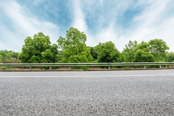 istock asphalt road and green forest under the blue sky 868005318