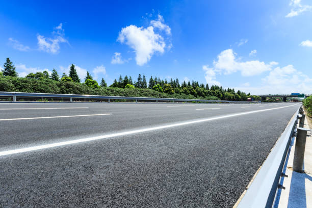istock asphalt road and green forest under the blue sky 868005326