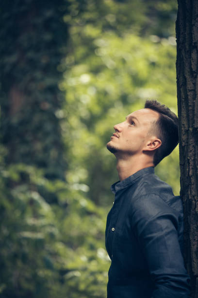 istock Attractive young man by the tree in park 868005722