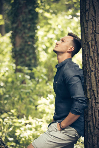 istock Attractive young man by the tree in park 868005766