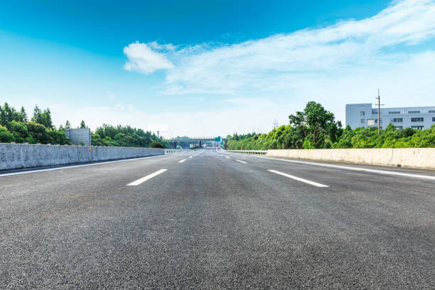 istock asphalt road and green forest under the blue sky 868006026